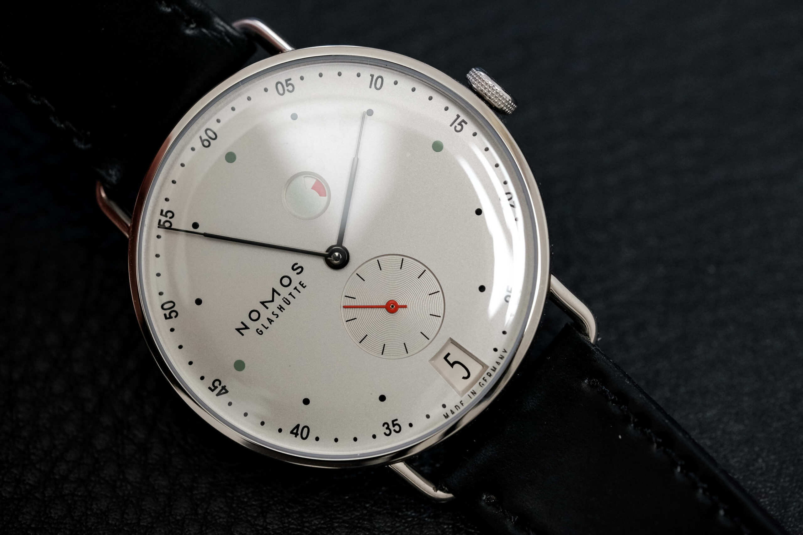 Nomos metro power reserve date dial macro close up